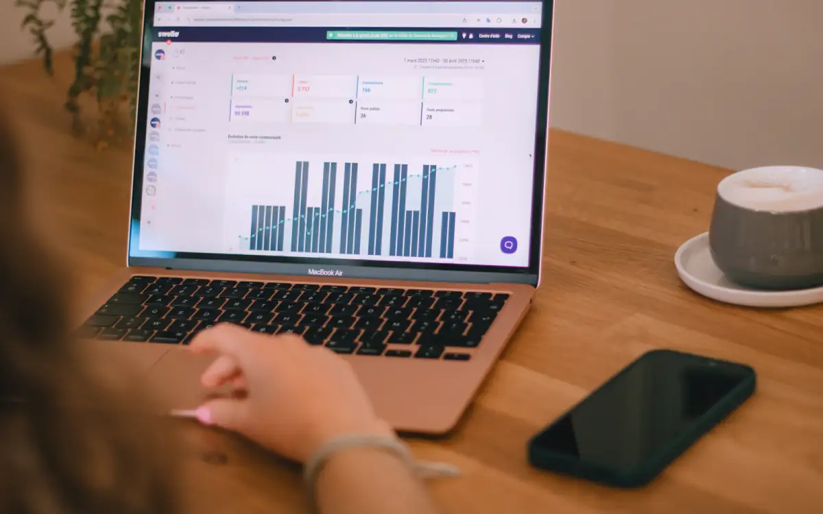 A laptop showing workflow charts on a desk
