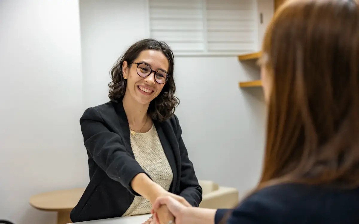 A recruiter shaking hands with a candidate after an interview